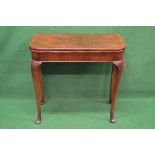 20th century mahogany card table having cross banded top opening to reveal floral decorated baize,