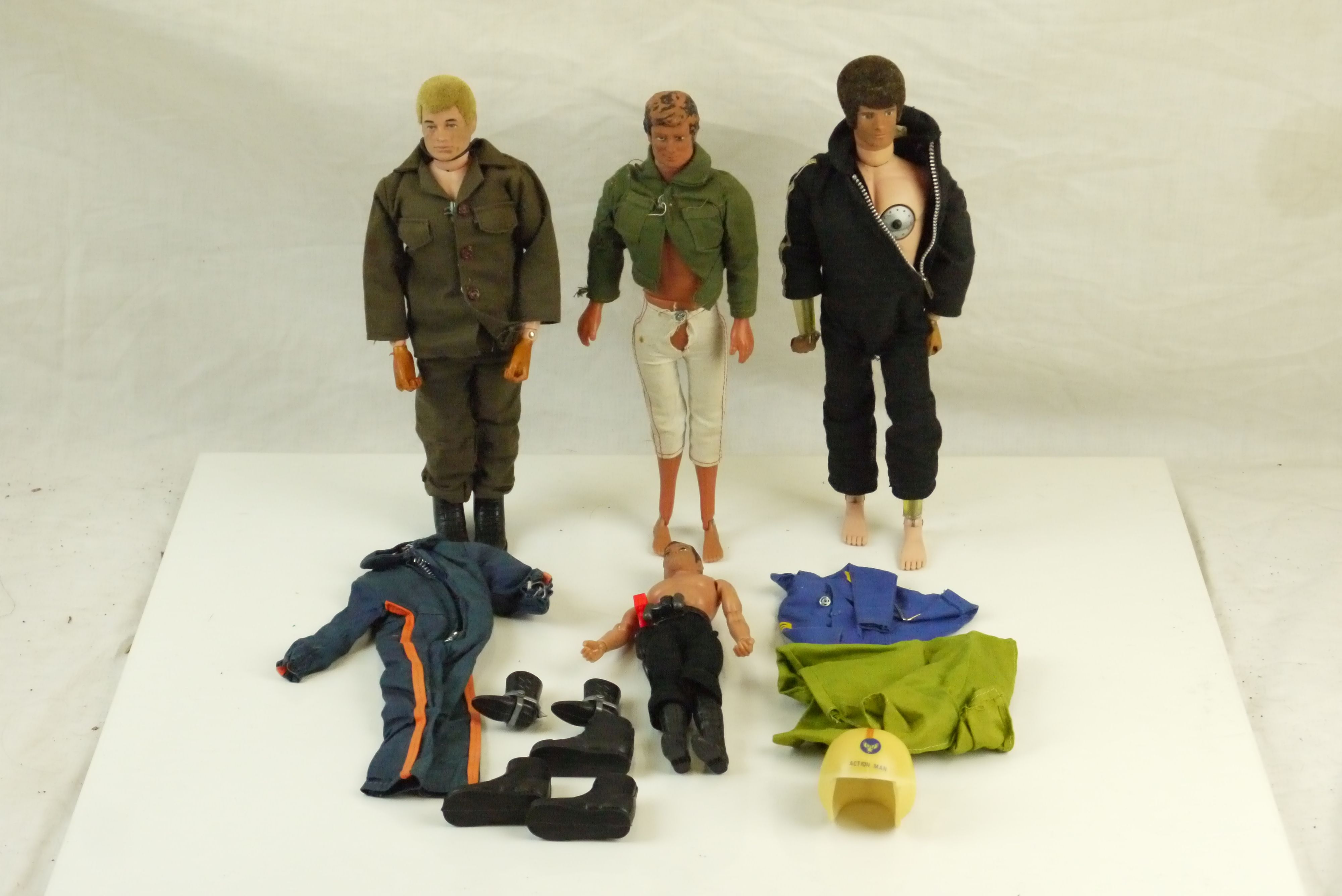 Two original Palitoy Action Man figures plus a 1974 Mego James Bond 007 figure and one other,