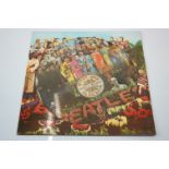 Vinyl - The Beatles Sgt Pepper (PHO 7027) picture disc West German pressing. Vinyl has slight chip