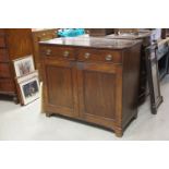Early 19th century Mahogany Cupboard / Sideboard, the Two Drawers with oval brass handles, over