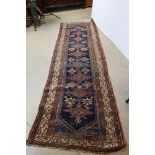 Eastern Wool Runner Rug, the central panel with a geometric pattern on a blue ground surrounded by a
