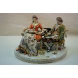 A 20th century Capodimonte porcelain group of an artist with lady.