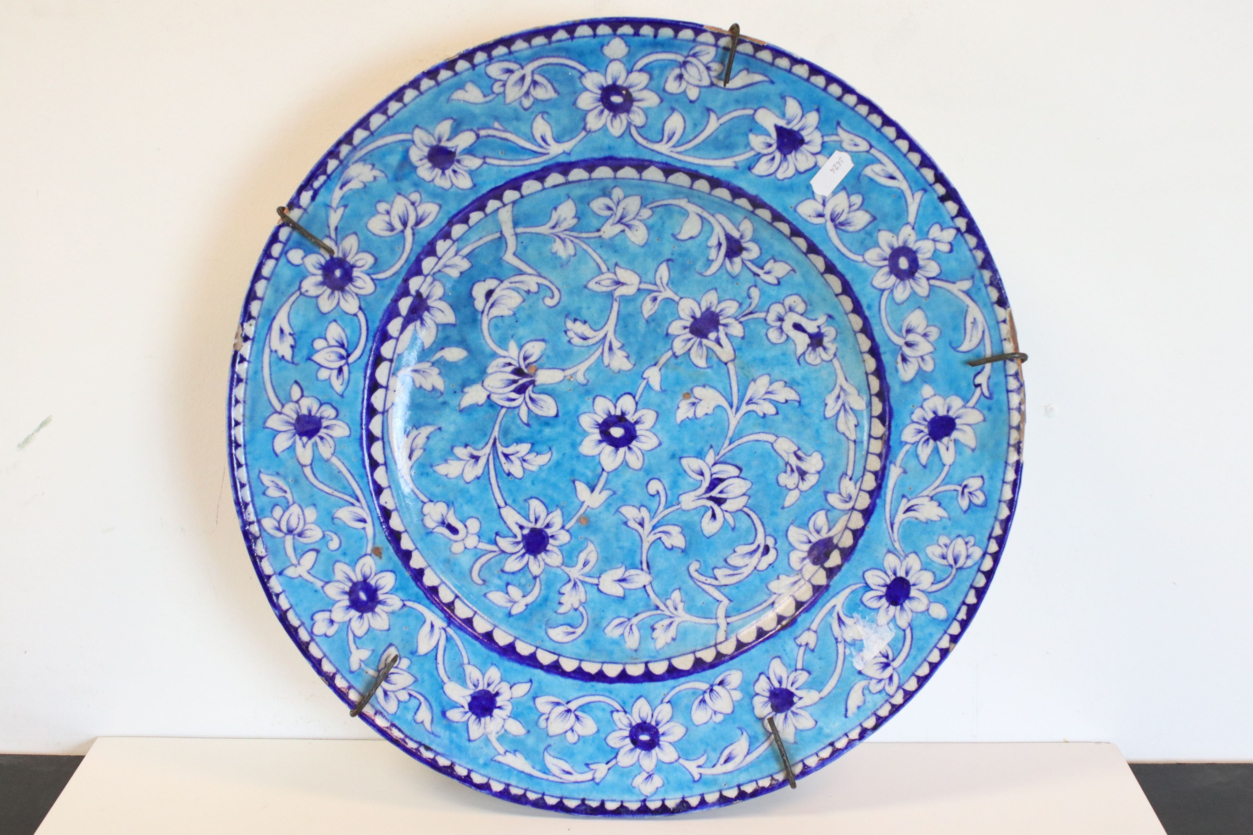 Large Iznic style ceramic Charger with Floral decoration on blue ground, 43cms diameter