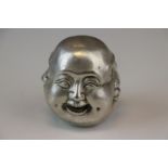 A white metal paperweight in the form of a four faced Buddha signed with character marks.