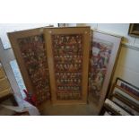 A pair of framed and glazed Tibetan paintings of head portraits of men and women together with a