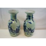 A large pair of ceramic oriental vases decorated with figures in a garden setting. 46 cm tall