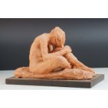 A contemporary unglazed sculpture of a male figure by Ivor Plummer.