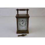 A French made brass carriage clock with white enamel dial, complete with key.