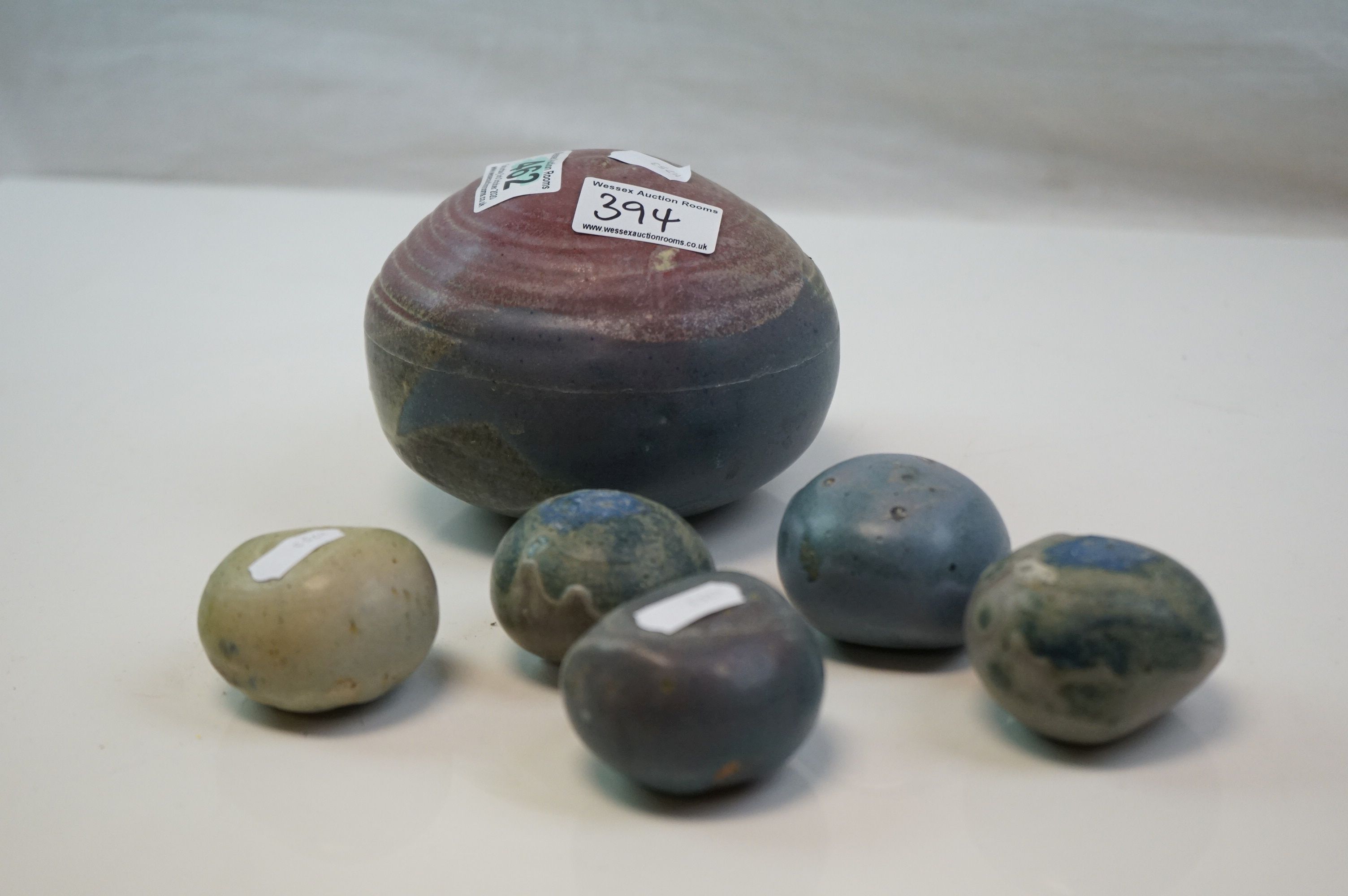 Five studio pottery sculptures in the form of stones together with one other larger no makers mark.