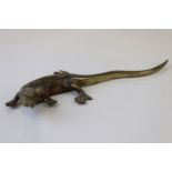 A bronze/brass lizard figure.