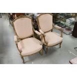 Pair of Louis XV style Open Armchairs, the giltwood frame with floral carving to top rail, carved