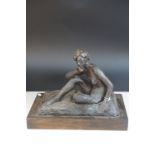 Contemporary sculpture of a seated naked woman raised on a wooden plinth by Ivor Plummer, 31cms long