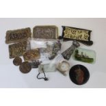 A small box of collectables to include brass badges and panels