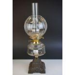 Victorian Oil Lamp with clear glass well and stepped cast iron base, bulbous fluted clear glass
