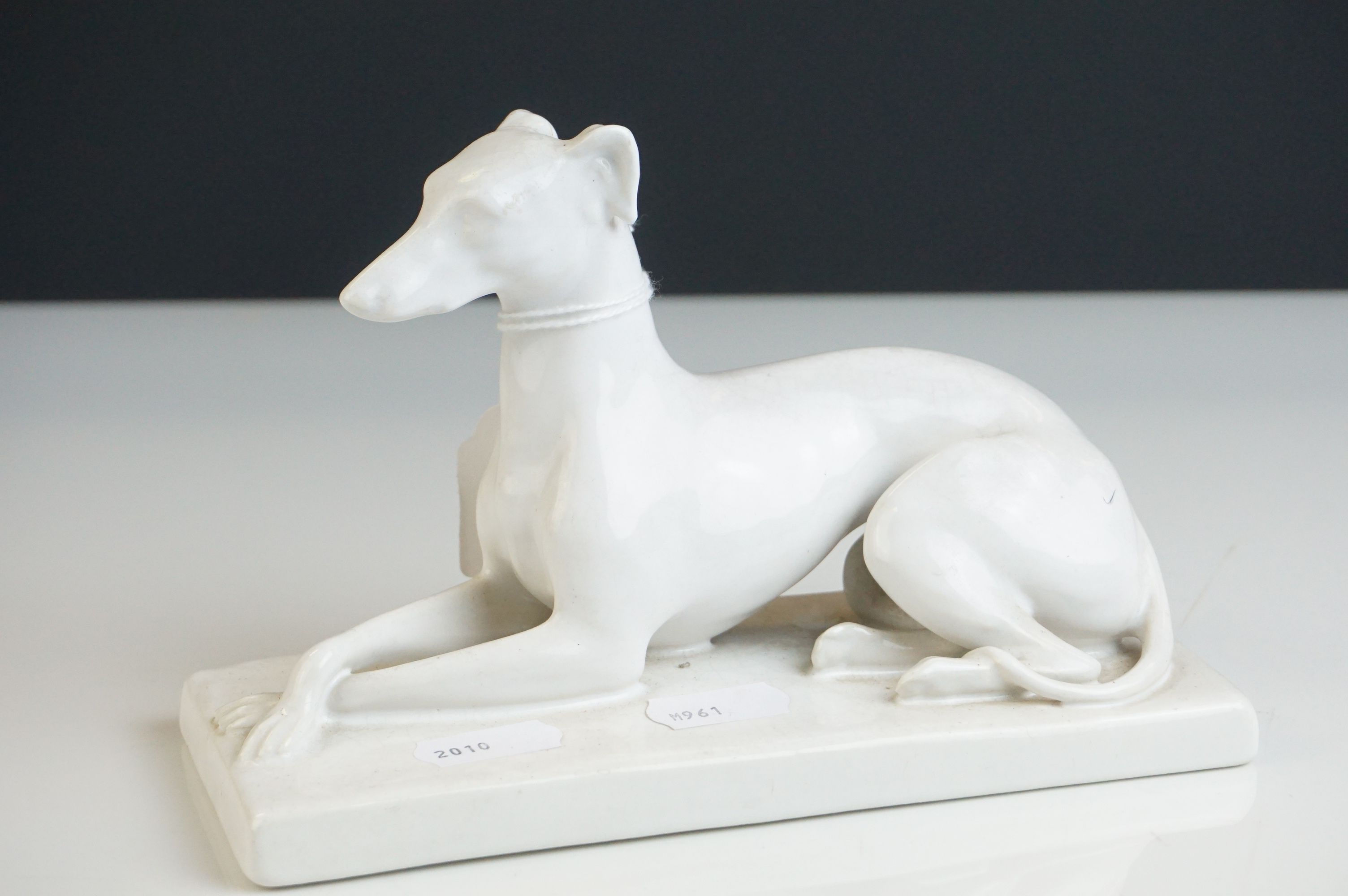 Minton's blanc de chine ceramic recumbent Greyhound dog marked to underside Mintons England, 18cms