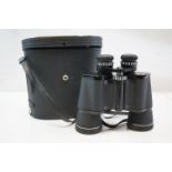 A pair of cased Prinz binoculars together with two others.