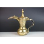 An Arabic Dallah brass coffee pot.