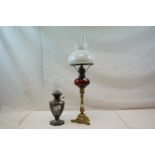 An early 20th century pewter oil lamp with engraved decoration, floral patterned shade and glass