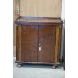 William IV Mahogany Cabinet, the top with gallery rail, over two panel doors flanked by brass capped