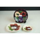 Three Moorcroft Pin Dishes, two in the Hibiscus pattern on white grounds and the other in the