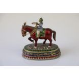 A miniature figure on horseback ornament with cloisonne decoration.
