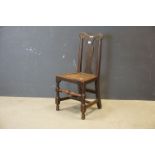 George II Oak Country Chair with bowed top rail and vase shaped splat, solid seat and raised on