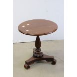 William IV Mahogany and Rosewood Circular Wine / Lamp Table raised on a turned baluster column