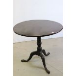 George III Oak Circular Tilt Top Supper Table, raised on a turned column and three splay legs, 82cms