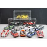 12 Slot cars to include Hornby Scalextric, Ninco, SCRSprit and Fly with 2 x car display cases