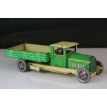 Early to mid 20th C tin plate clockwork tipper truck in green and cream, made in England, good