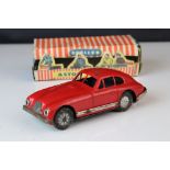 Boxed Scalex tin plate clockwork Aston Martin DB2 model in red, showing play wear with wear to