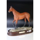 Royal Doulton model of Red Rum DA218, no. 1132, on wooden plinth with name plaque, 36cms high