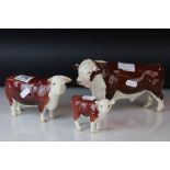 A Beswick group of Hereford bull cow and calf the cow marked champion of Champs.