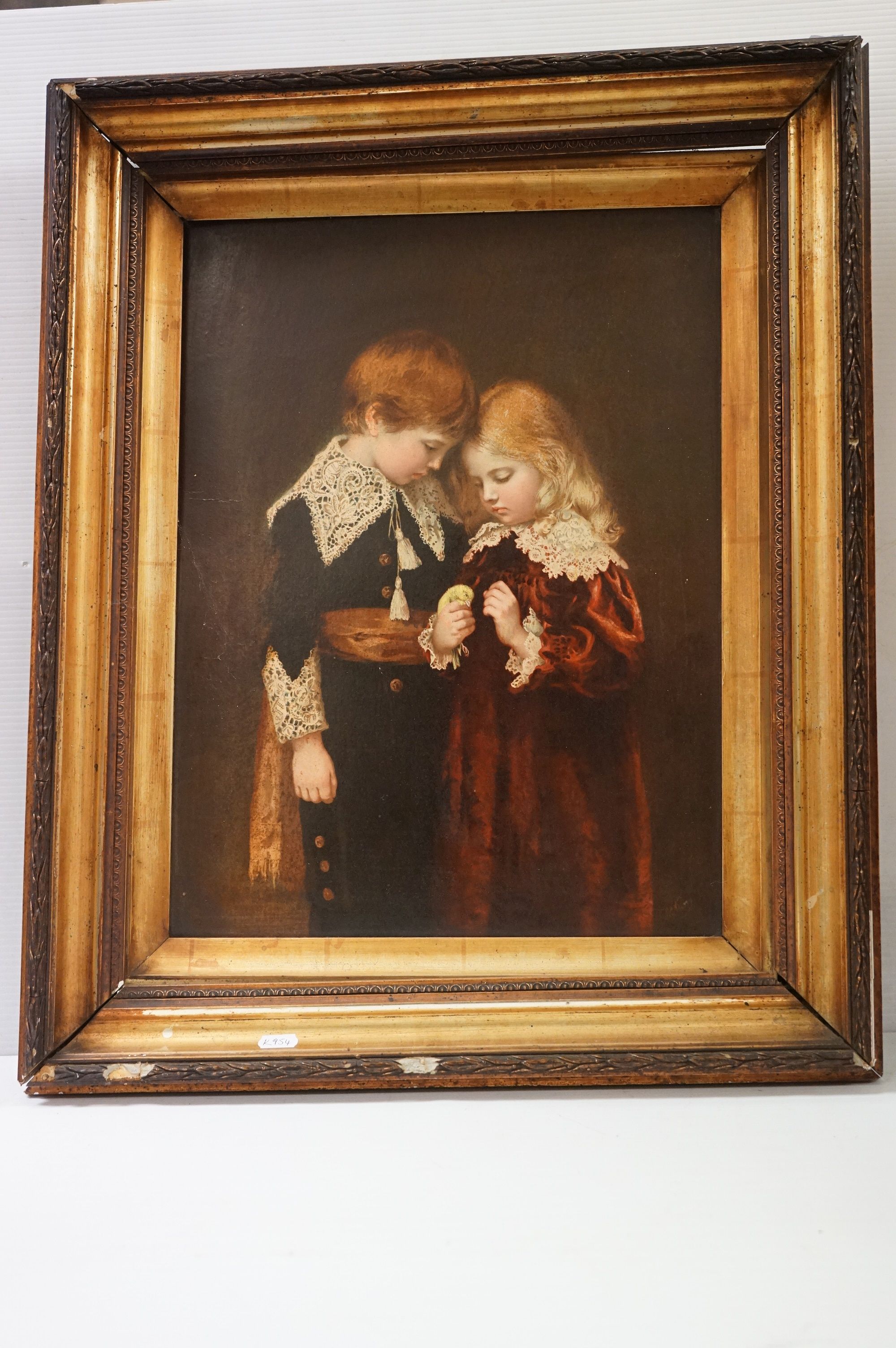 A vintage framed coloured print of a young girl and boy in 19th century costume.