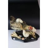 Taxidermy Hen / Chicken with Three Chicks, mounted on a plinth base with sheaths of corn, 33cms long