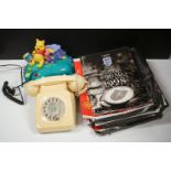 A box of mixed collectables to include two vintage telephones and a selection of football