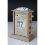 A reproduction wooden desk top perpetual calendar