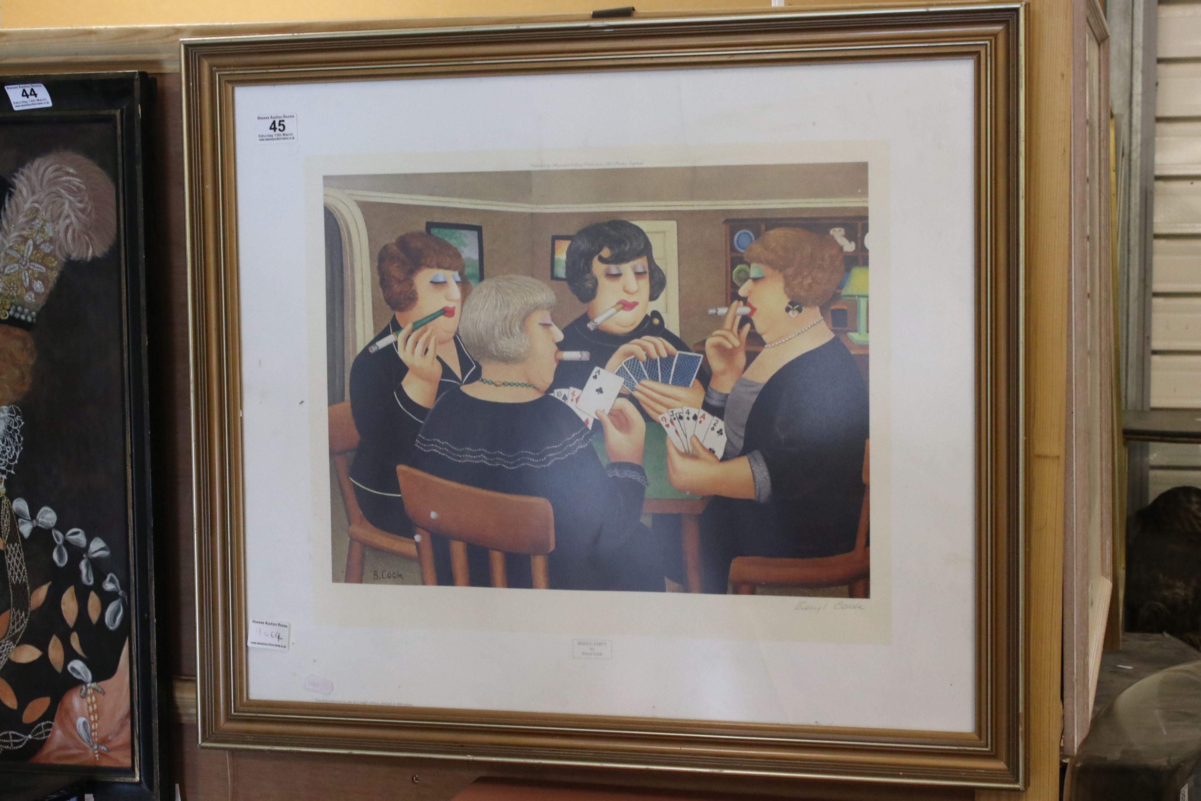A framed and glazed limited edition print by Beryl Cook women playing cards signed in pencil.