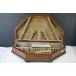 A vintage wooden cutlery box containing mixed collectables to include coins, a netsuke and a fan.