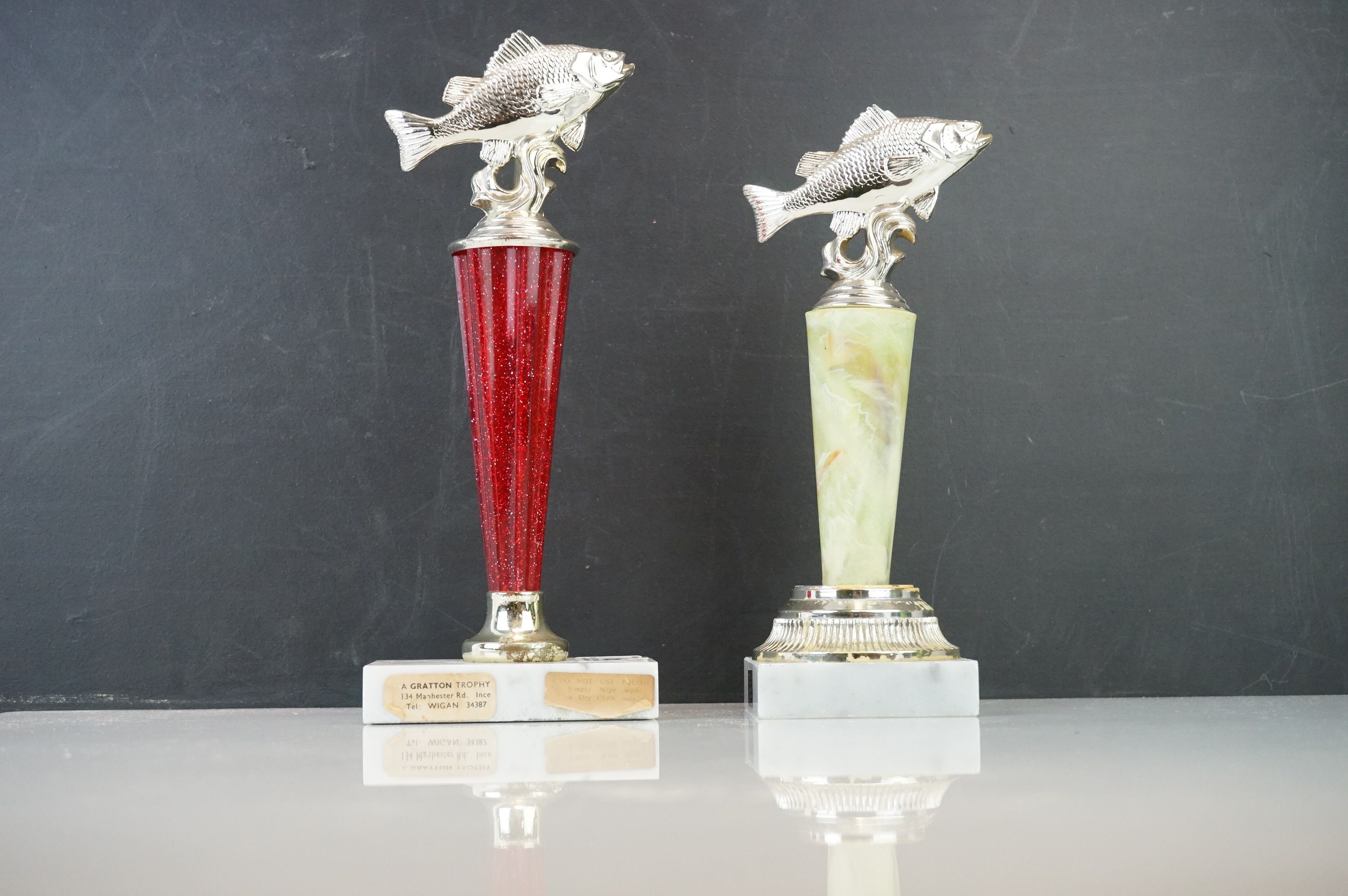 Two fishing trophies on marble bases