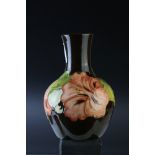 A contemporary Moorcroft brown ground vase with Hibiscus pattern 13 cm in height.