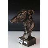 A metal bronzed head of a greyhound dog