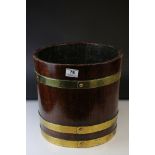 A vintage coopered brass bound planter with label reading Made from The Battle ships of Britain Long