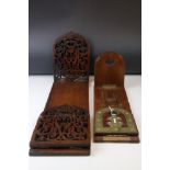 An antique hardwood book slide with pierced fretwork decoration together with a similar with brass