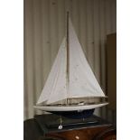 A model of a sailing yacht mounted on a plinth.