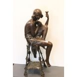 A large bronze sculpture of a seated Art Deco Style Flapper Girl. 68 cm tall