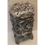 A novelty rubbish bin decorated in the form of a engineering style sculpture.