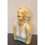 A plaster head and shoulder bust of Marilyn Monroe.