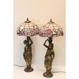 A pair of cast metal lamp bases in the form of classical women, with Tiffany style shades