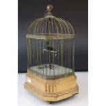 A vintage automaton bird in a cage.